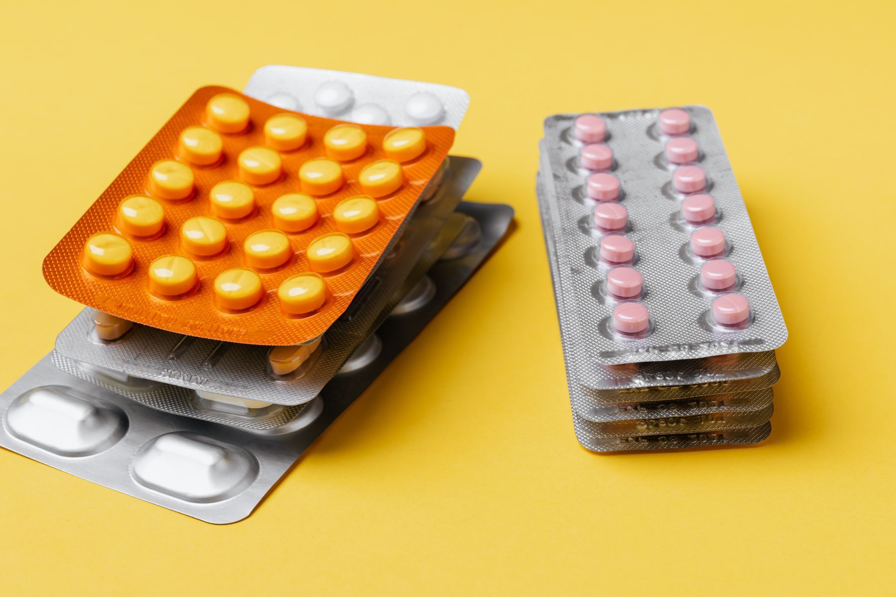 A stack of assorted medicines in blister packs